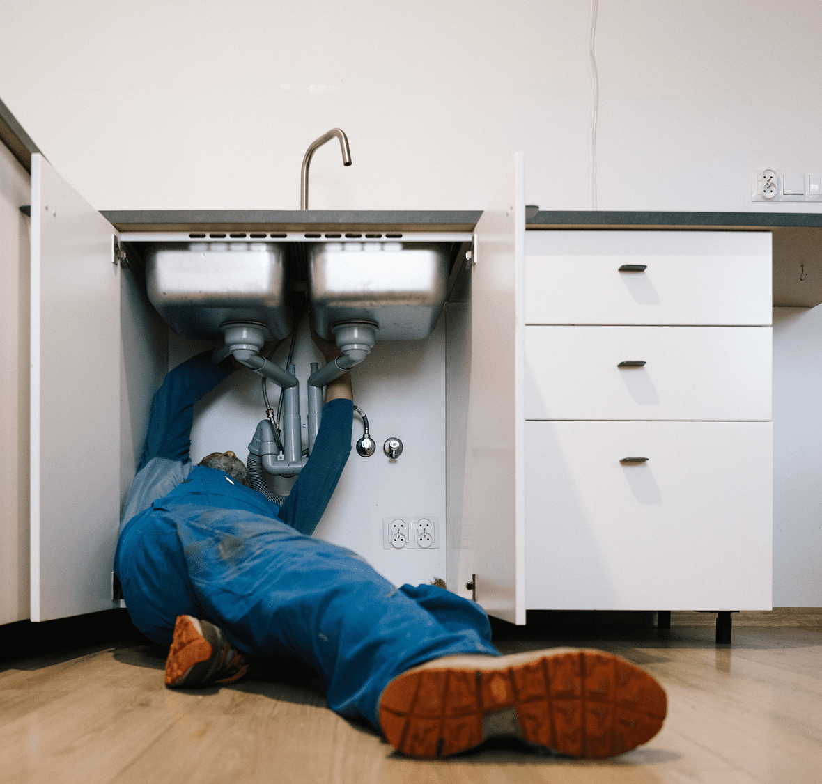 Person working under kitchen sink